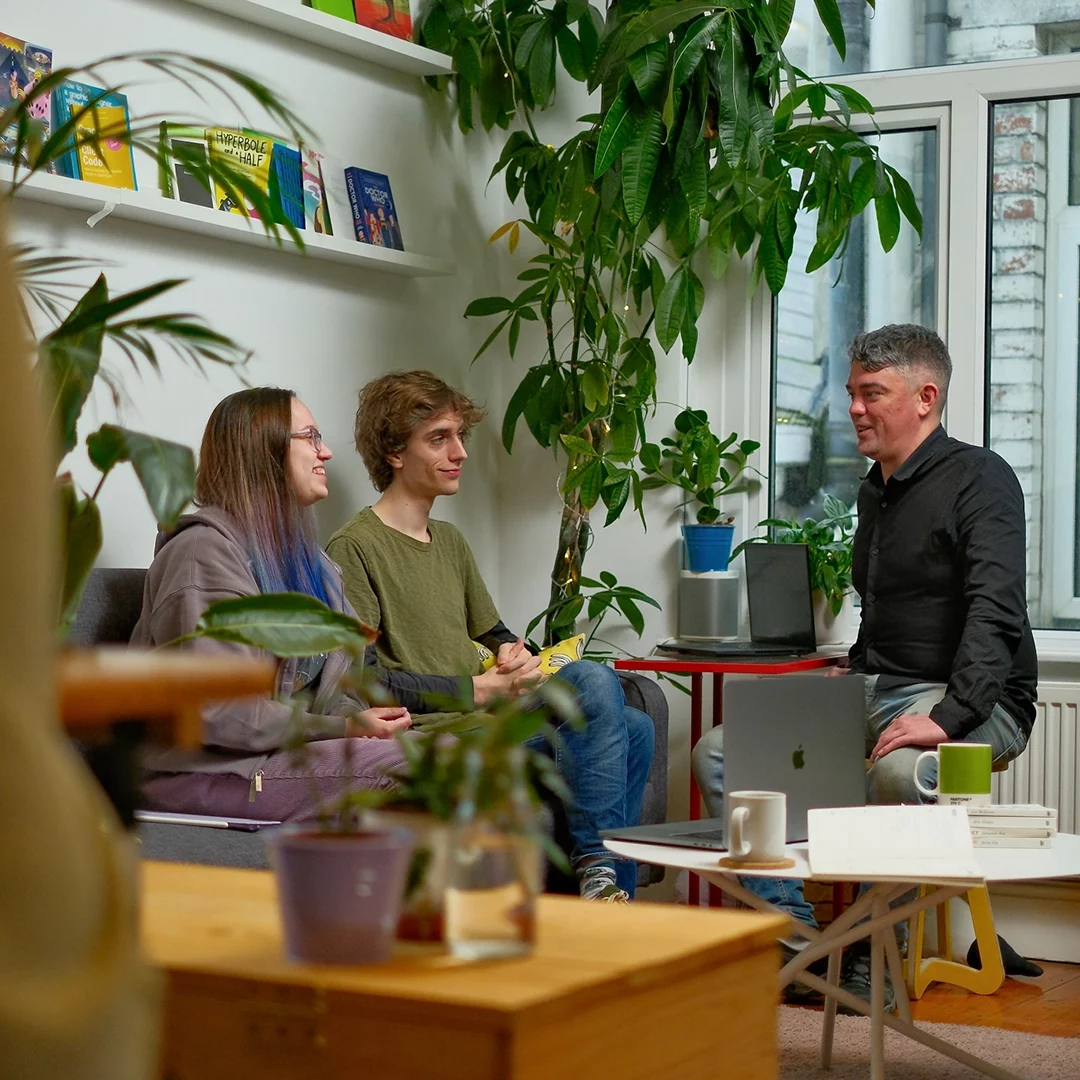 Three developers chatting in the office