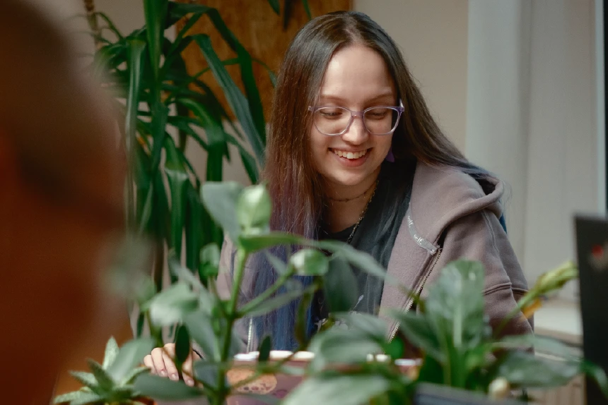 Awen looking down and smiling whilst working with the team.