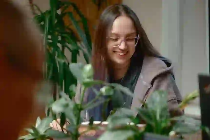 Awen looking down and smiling whilst working with the team.